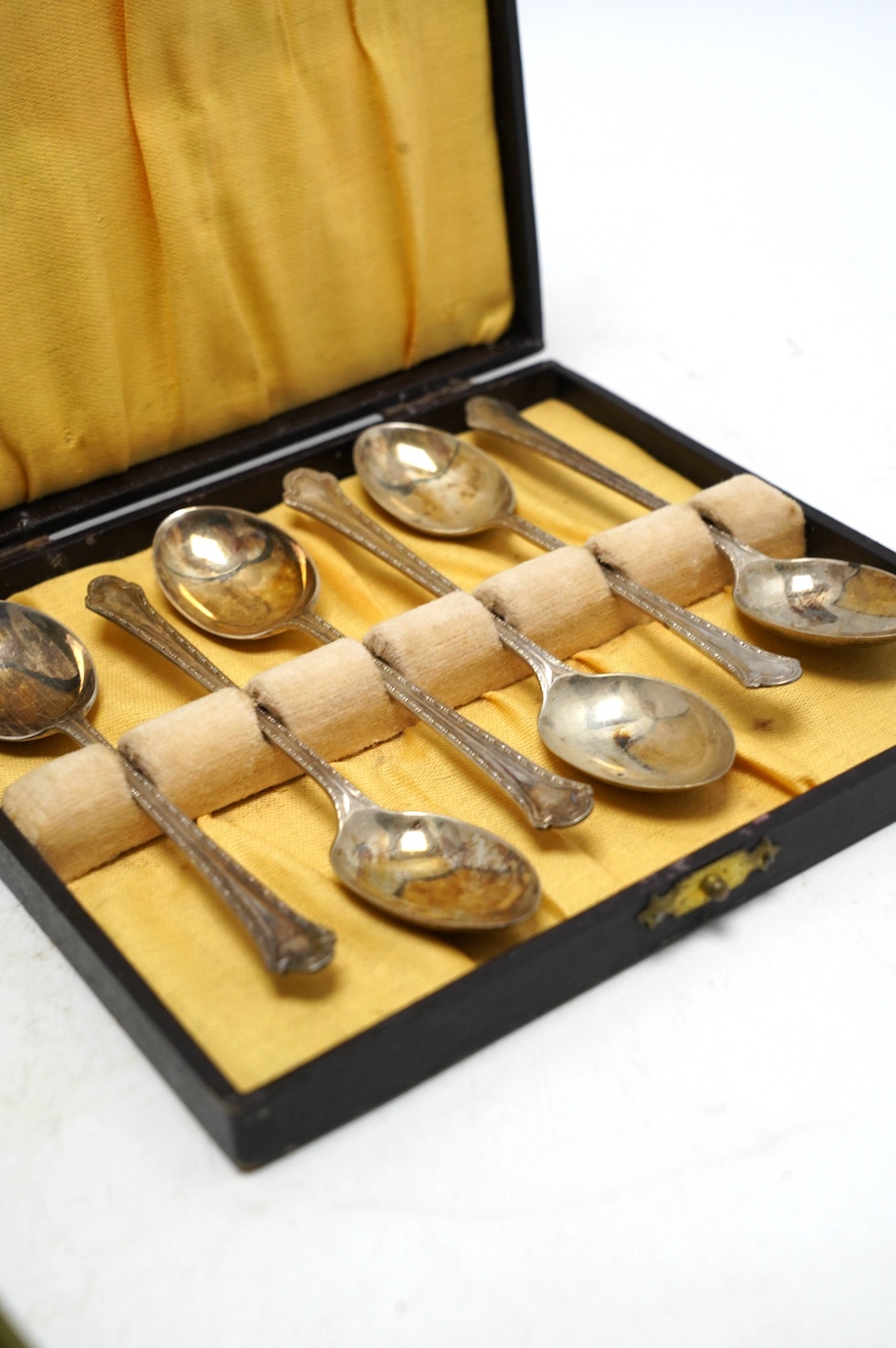 Sundry small silver including cased sets and loose flatware, condiments, a white metal tea strainer and peacock menu holders, etc. Condition - poor to fair